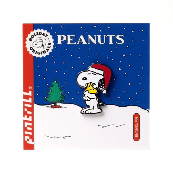 Peanuts holiday enamel pin with Snoopy in a Santa hat hugging Woodstock on a blue background