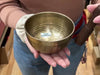 Someone using a Tibetan singing bowl