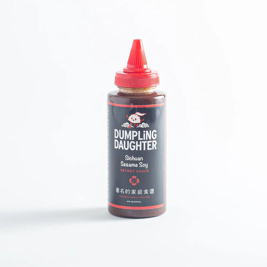 Squeeze bottle of Sichuan Sesame Soy Sauce with imagery of the Dumpling Daughter logo.