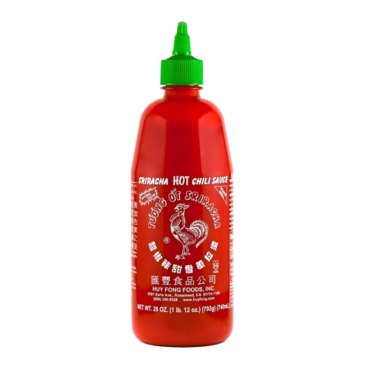 Bottle of Sriracha hot chili sauce with a green cap on a white background