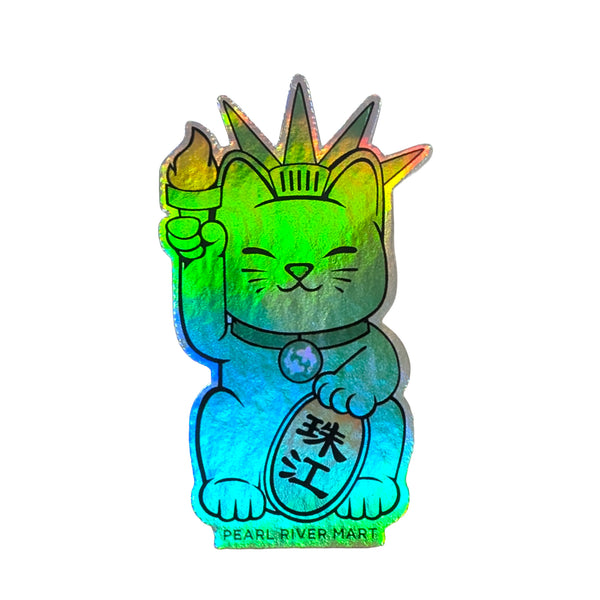 A cartoon maneki-neko cat styled like the Statue of Liberty, in mint green with a pink outline, holding a yellow-orange flame and a gold coin with Chinese characters. The text 'PEARL RIVER MART' appears below.