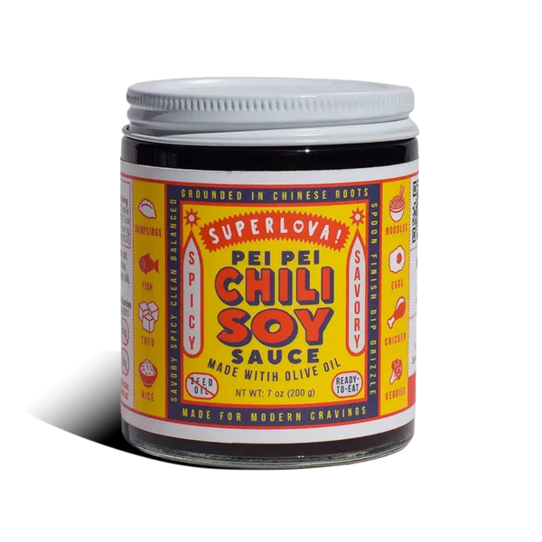 A jar of SuperLoyal Pei Pei Chili Soy Sauce on a white background with a soft shadow. The product features a bright yellow label with red and blue text, and a white metal lid.