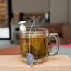 Tea holder fishermen on edge of mug with tea