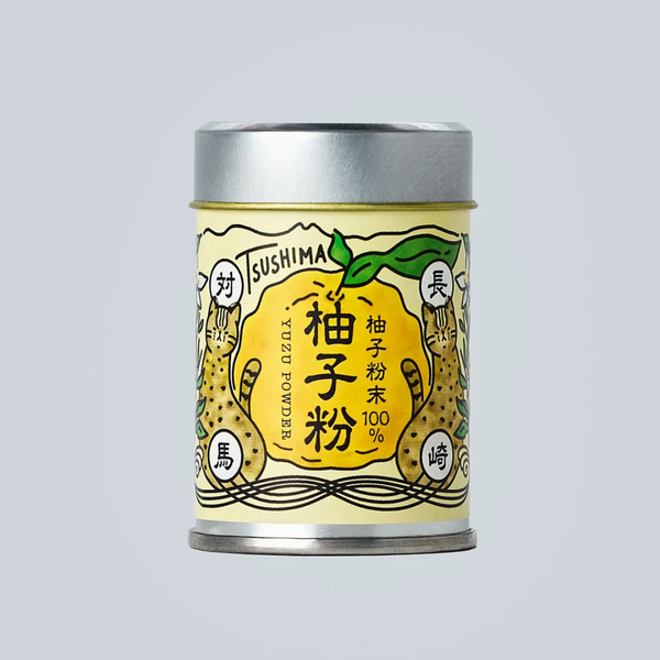 Canister of Tsushima yuzu powder with a yellow label on a gray background