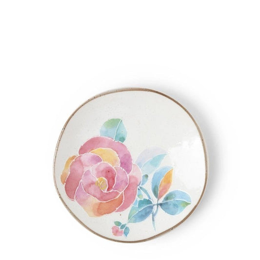 A small ceramic plate with a floral design, predominantly pink and yellow flower with a brown rim.