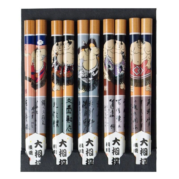 A set of five pairs of chopsticks with assorted sumo designs on each, displayed in a row against a white background.