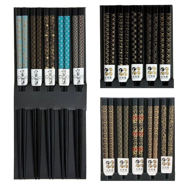 Five pairs of black chopsticks with assorted patterns.