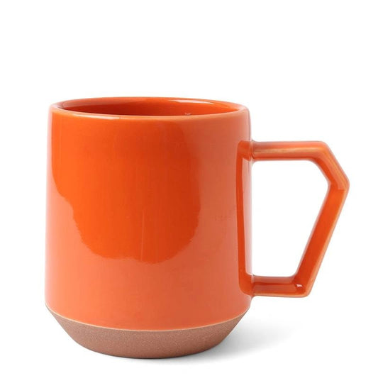 Bright orange mug with a hexagonal handle, glossy finish, and a matte brown base, set against a plain white background, exuding a modern vibe.