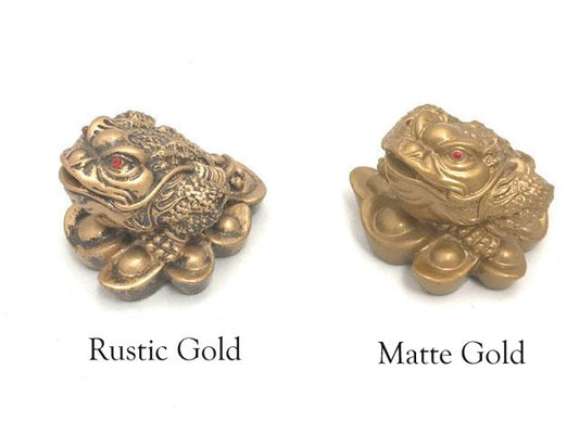 A pair of Three - legged toad(money frog) on ingots. One in rustic gold, the other in matte gold