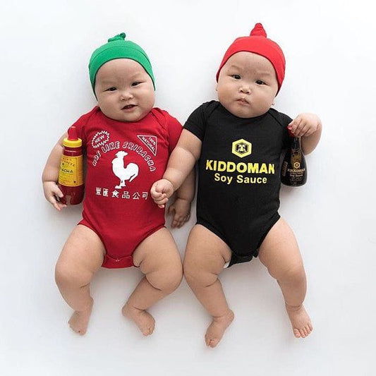 Chubby twin babies wearing Sriracha and soy sauce onesies