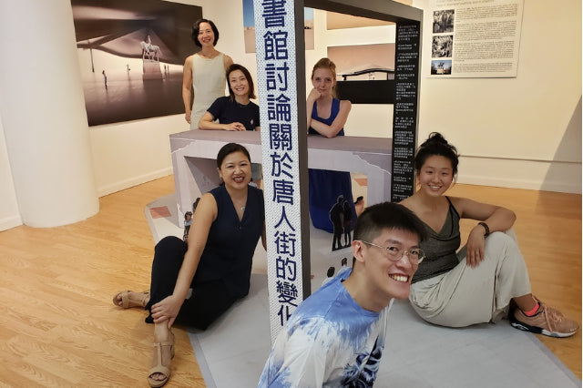 One man and four women in art gallery